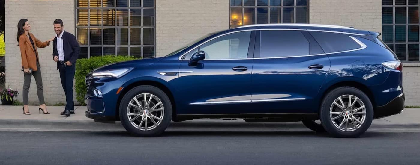 A blue 2024 Buick Enclave is shown parked near a Buick dealer near Manson.