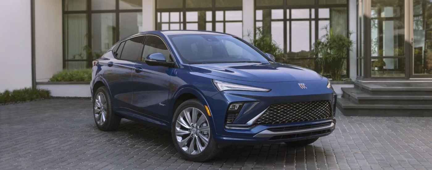 A blue 2024 Buick Envista Avenir is shown parked on a brick driveway.