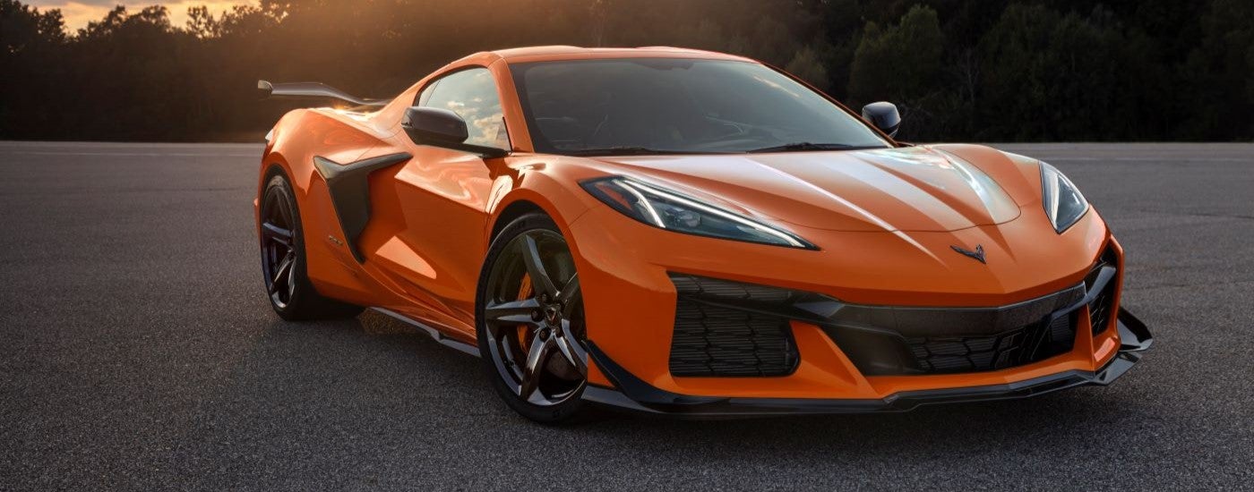 An orange 2023 Chevy Corvette Z06 is shown parked on pavement.
