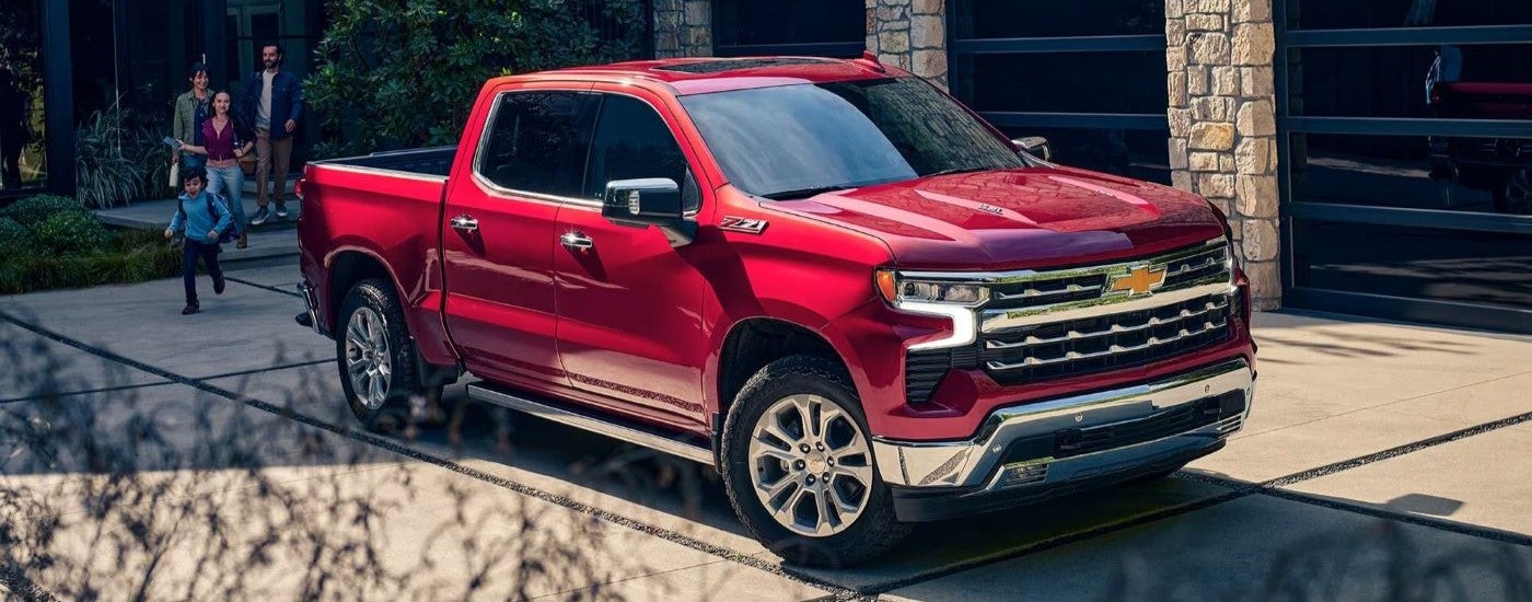 A red 2023 Chevy Silverado 1500 Z71 is shown parked on a driveway.