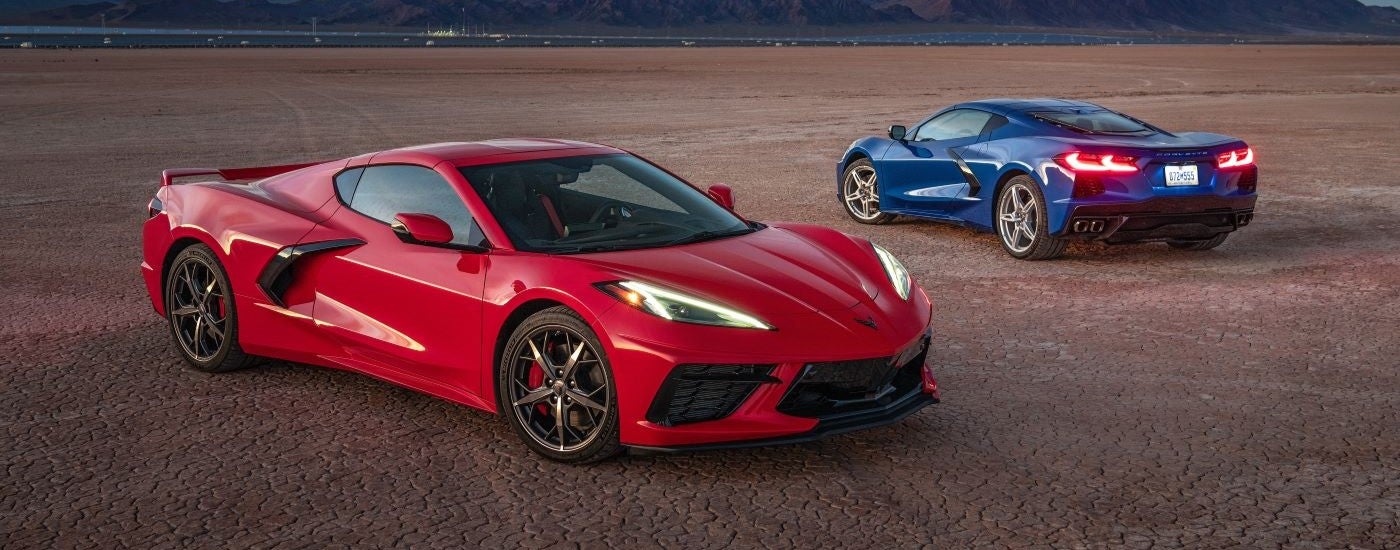 A red and a blue 2020 Chevy Corvette is shown parked facing different directions.